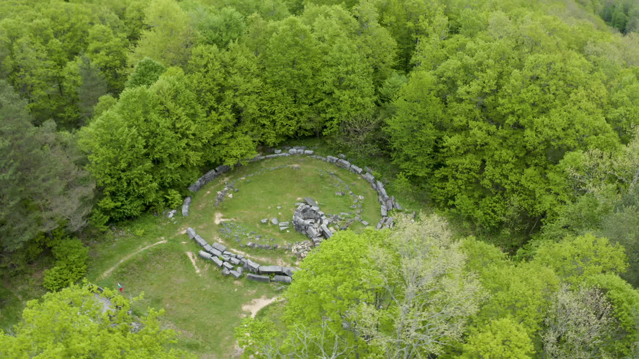 Circular drone shot above the ruins of Mishkova Niva tomb and its surrounding forest on Strandzha Mountain in the municipality of Malko Tarnovo in Bulgaria.
