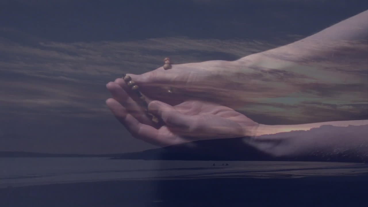 Holding sand, person at serene beach during dusk with animation effect