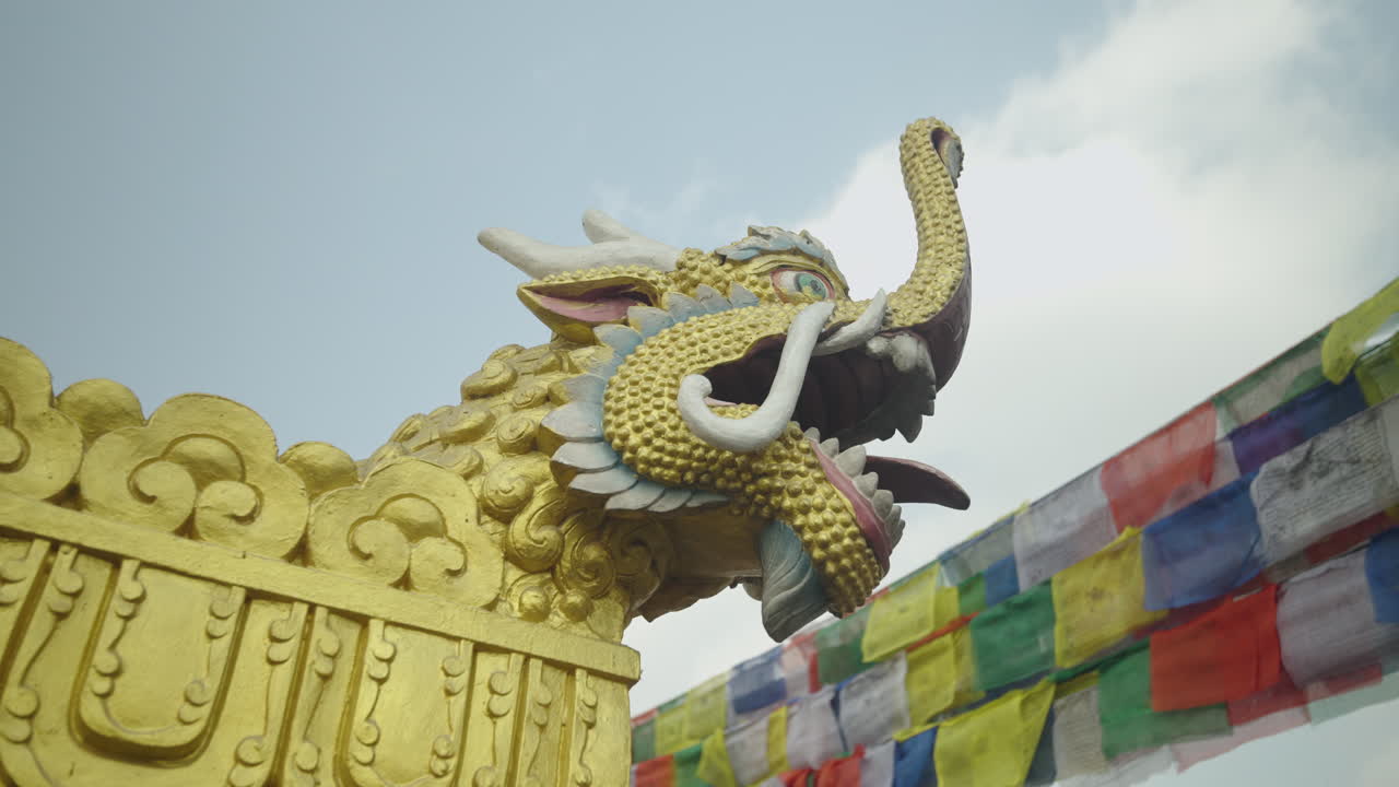 A tiger statue stands in a Buddhist temple in Nepal beneath the open sky. Prayer flags flutter around, symbolizing spiritual strength, peace, and harmony within Nepal’s sacred heritage