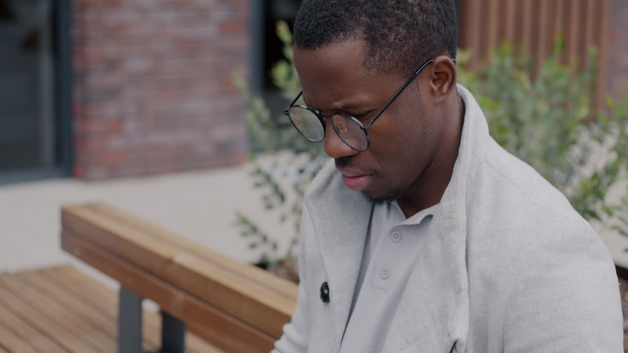 Man sitting outdoors on a bench