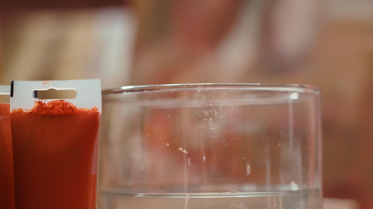 Paint tubes and a glass of water