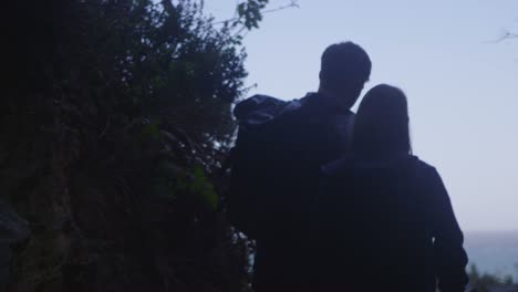 A-couple-walk-along-a-path-on-a-sea-cliff