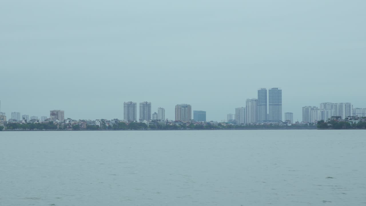 Hanoi Vietnam city skyline Cai River cruise view modern buildings Southeast Asia
