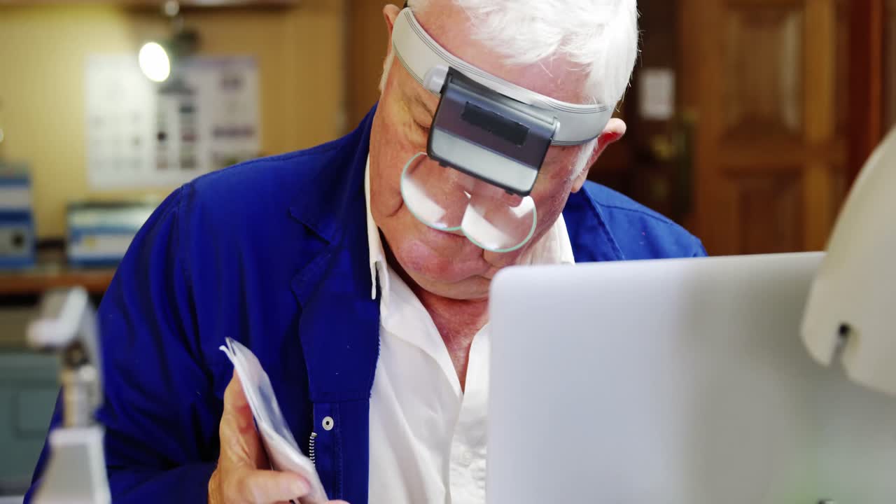 Horologist using laptop