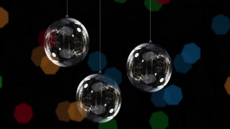 animation of clear baubles and christmas fairy lights flickering over black background