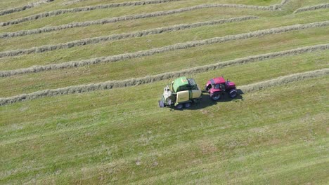 aerial shot of tractor making hackstacks
swiss countryside