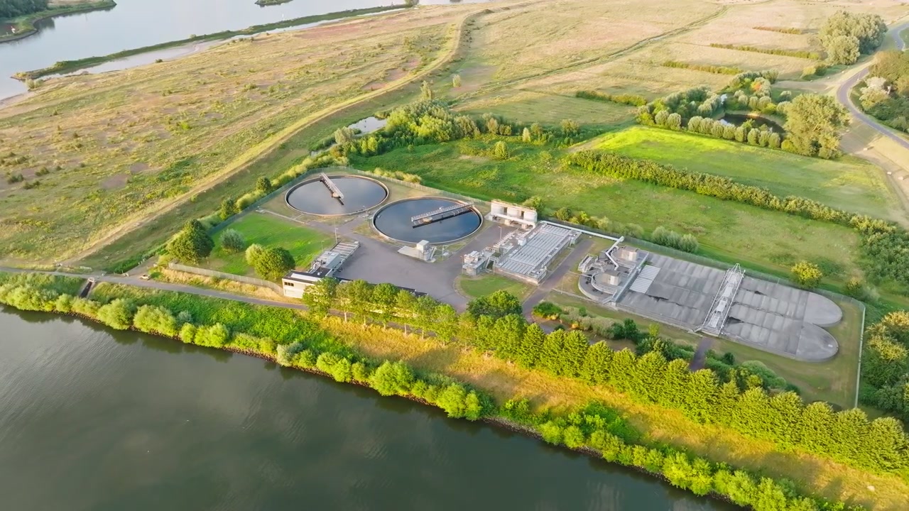 Aerial orbit water treatment plant with round sedimentation tanks and filter basins surrounded cleaning water ecofriendly