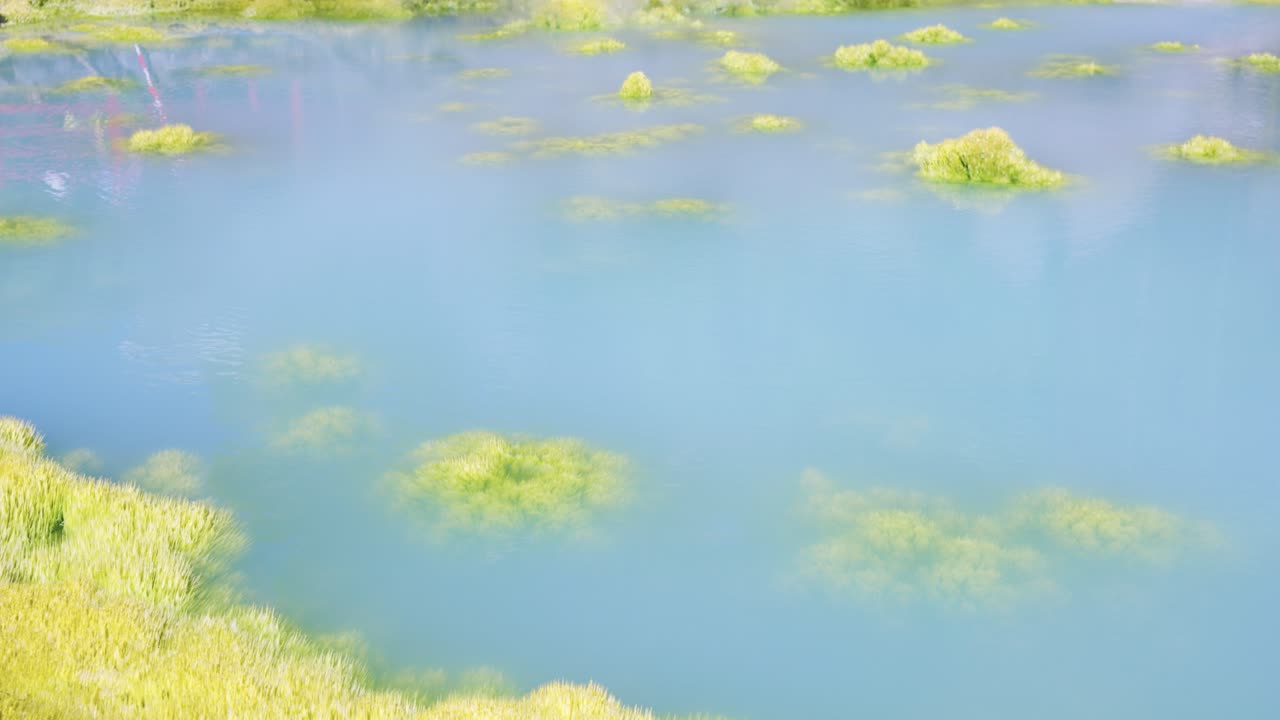 Kamado Jigoku, Bright Blue Sulfur Geothermal Pool Steaming in Beppu, Japan