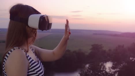 woman experiencing virtual reality at sunset