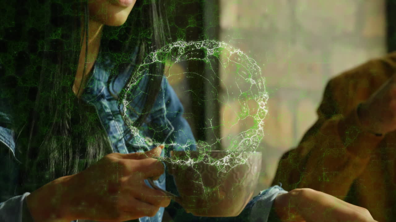 woman holding patterned mug indoors, displaying green holographic ring for technology presentation