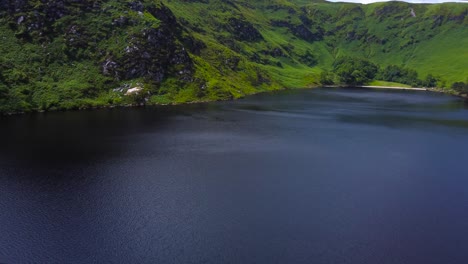 aerial reveal of a beautiful mountain landscape and a lake in ireland's mountains