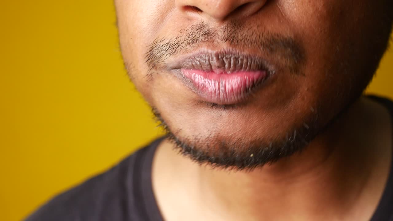 Close-up of a person eating french fries and pursing their lips