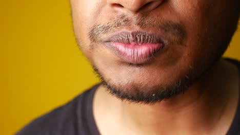 close-up of a person eating french fries and pursing their lips