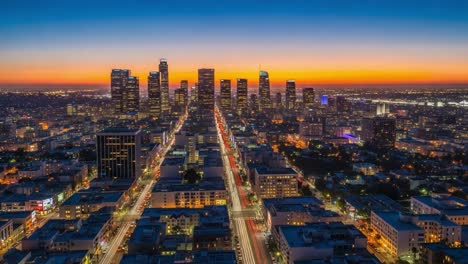 city skyline at dusk with traffic light trails