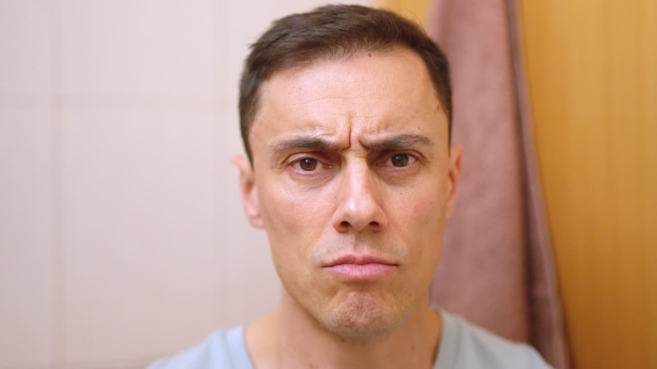 Man drying and styling hair in bathroom