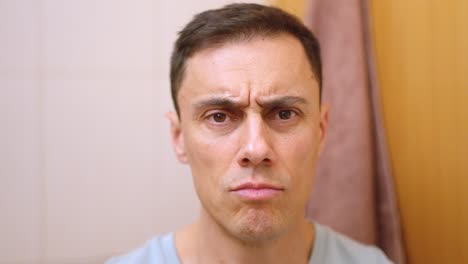 man drying and styling hair in bathroom