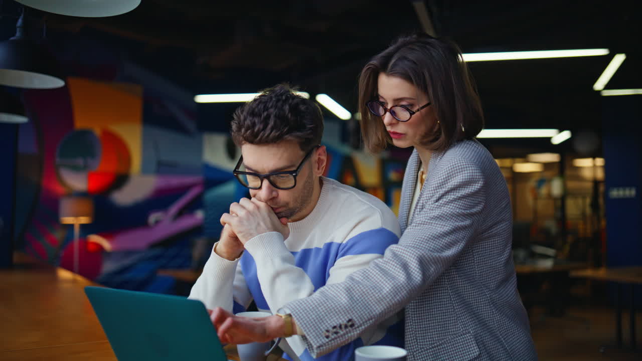 Professional man woman discussing project sitting creative agency hall closeup