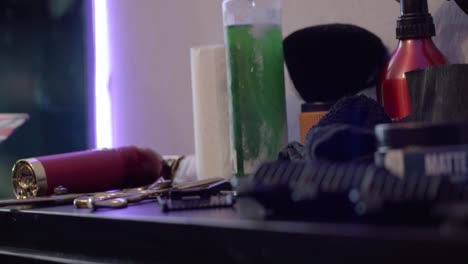 barber tools on a counter in a dimly lit barbershop, captured up close