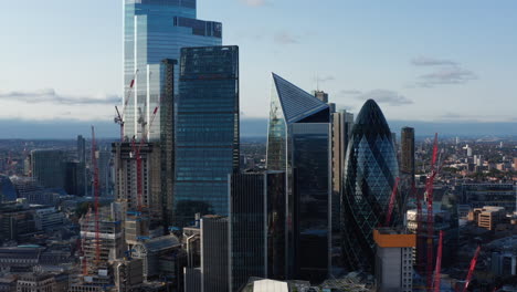 Slide-and-pan-footage-of-futuristic-office-buildings-in-City.-Gherkin,-Scalpel-and-other-iconic-modern-skyscrapers.-London,-UK