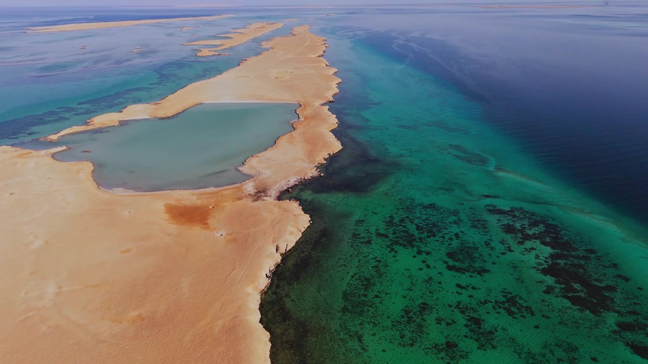 Drone footage of Juzur Ashrafi Island, Egypt, showcasing turquoise waters in an isolated and remote place of the Red Sea, Africa.