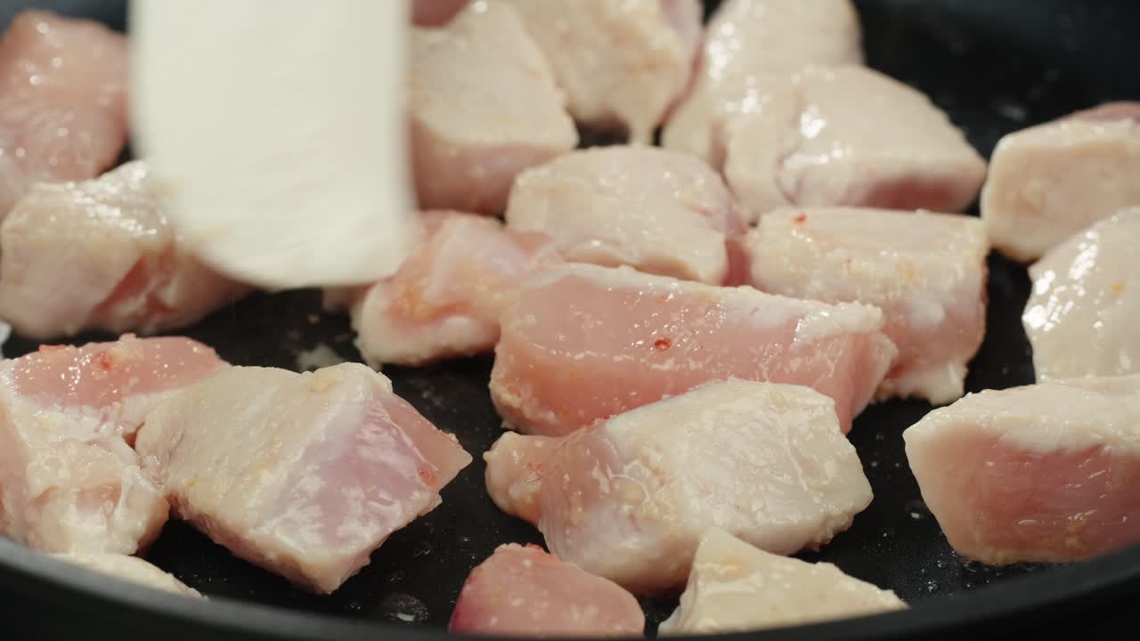 Man slicing raw turkey or chicken meat fillet on oak cutting board closeup, cooking with knife on restaurant kitchen. High quality 4k footage