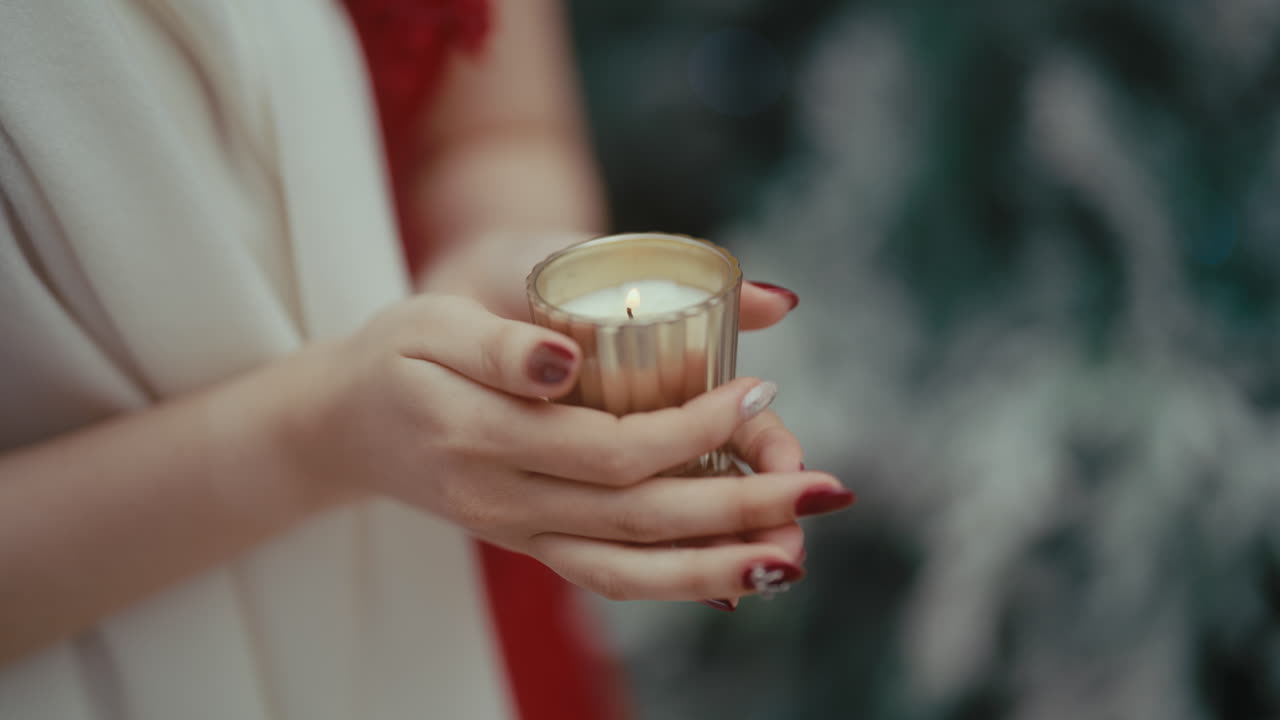 Woman Holding a Christmas Candle