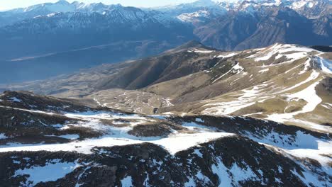 Aerial-beautiful-view-of-steep-cliffs-covered-with-snow-on-natural-mountain-sightseeing