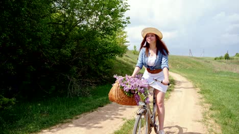 woman in a hat on a bicycle traveling in nature