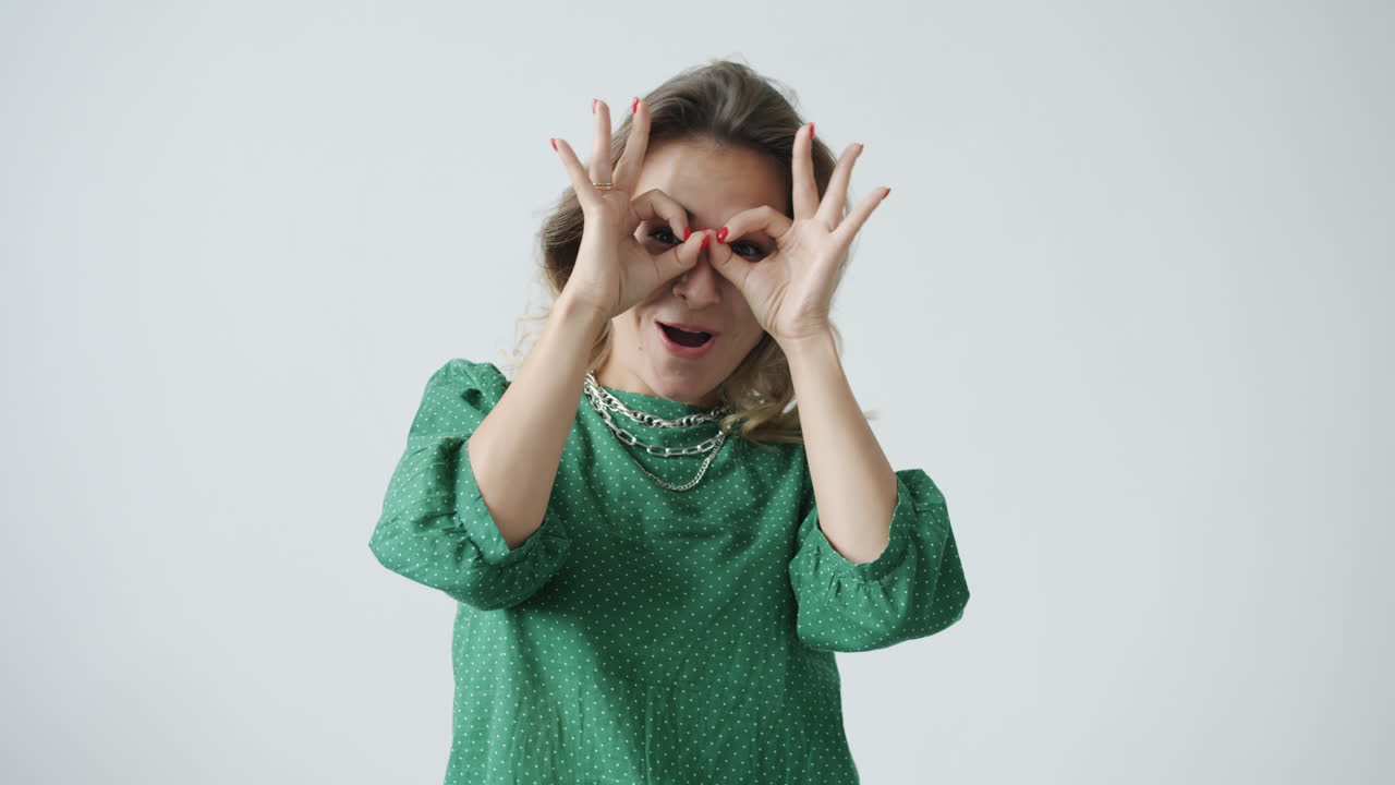 Woman in a Green Dress with Ok Gesture