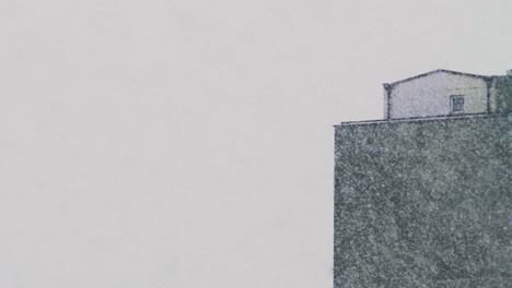 the top of an estate tower during heavy snowfalls