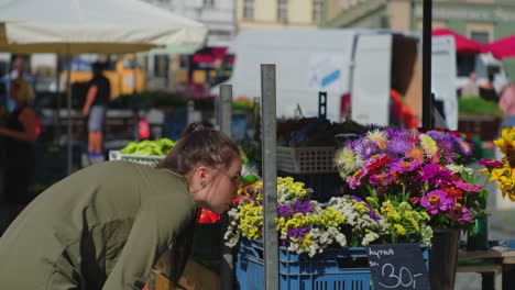 woman shopping for flowers at a market