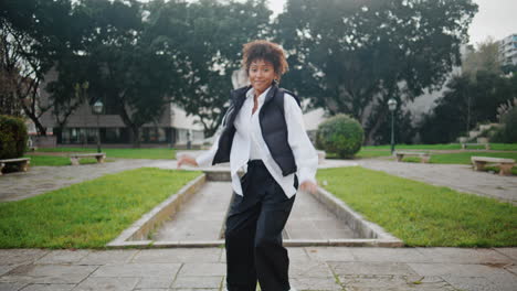 Woman-hip-hop-dancer-performing-energetic-movements-in-city-park.-Girl-dancing