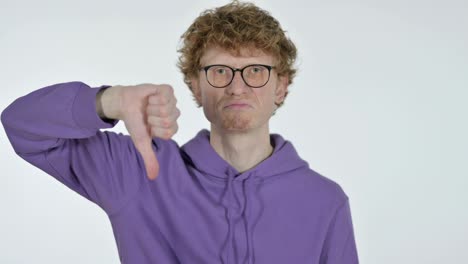 thumbs down by redhead young man, white background