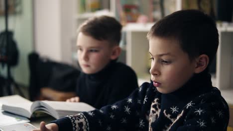 slow motion footage of two little boys sitting in front of their laptops. programming class. alternative education for children.