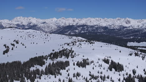 ptarmigan hill vail pass colorado aerial drone rocky mountains holy cross indian peaks sunny bluebird sky cold winter morning i70 deep powder backcountry snowboarding ski snowmobile forward reveal