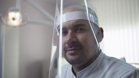 a medical professional wearing a face shield in a clinic