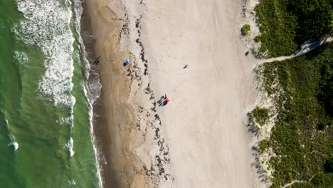 Aerial-of-Tourists-on-Vacation-with-Beach-Umbrella-in-Cocoa,-Florida