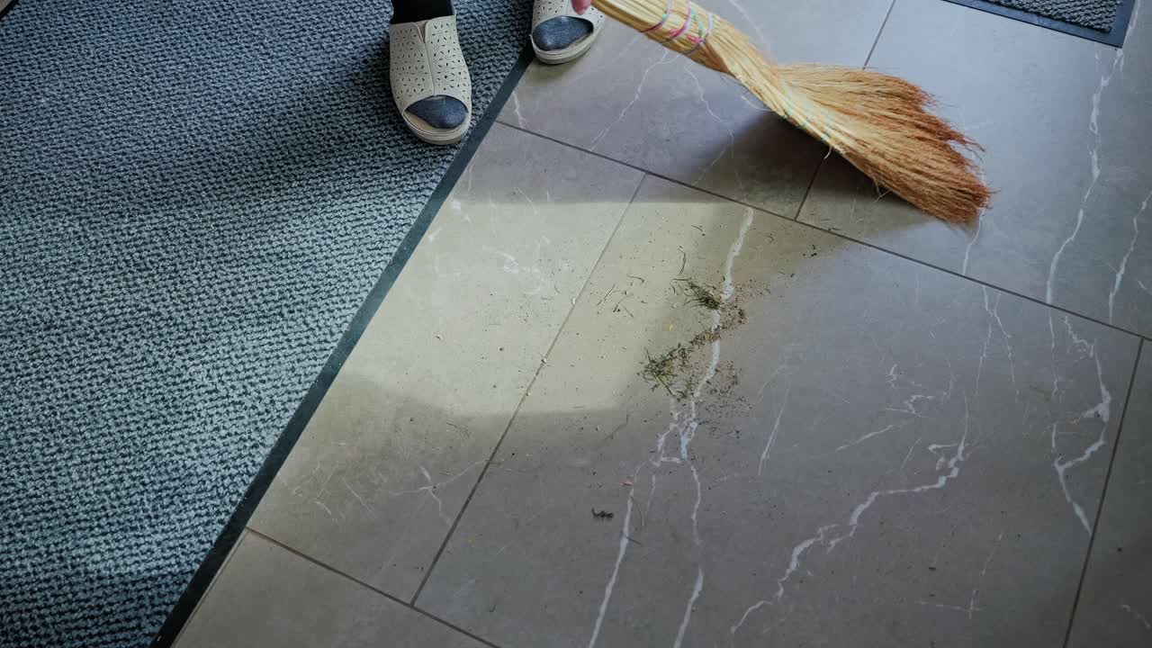 Sunlight casts shadows as elderly hand tidies peaceful home entrance floo
