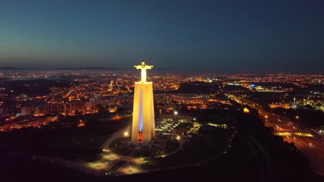 imágenes de aviones no tripulados volando directamente hacia y pasando la estatua de cristo rey en almada