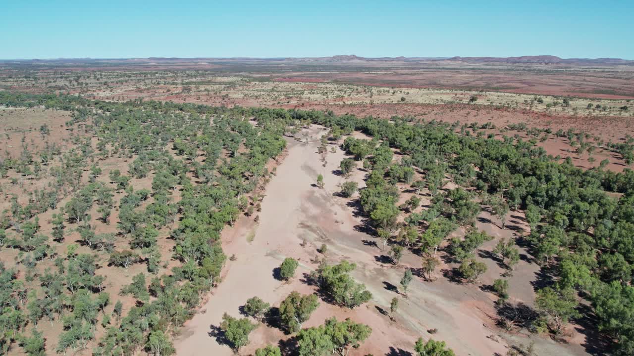 Sideways drone footage of the Finke River near the Stuart Highway in the Northern Territory, Australia. August 2022.