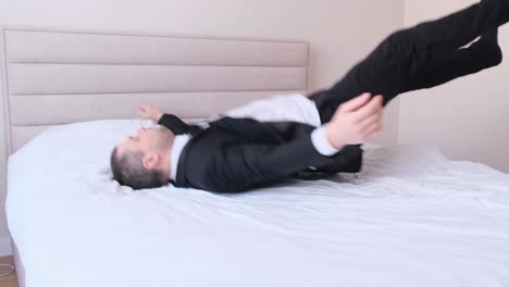 exhausted businessman in office clothes lying on bed at home after work side view exhausted businessman in office clothes lying on bed at home after work side view tired after working in the office video