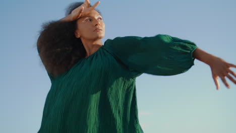 woman performing dance nature windy day close up. african american girl dancing.