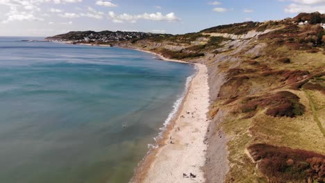 aerial view of charmouth beach and cliffs with turquoise waters in dorset