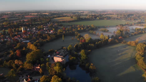 aerial footage of dedham featuring the village and church in the early morning with mist lying in the fields