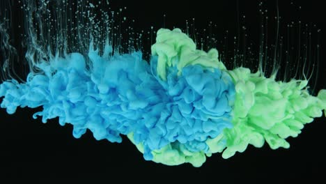 colors colliding together underwater in slow motion on black background