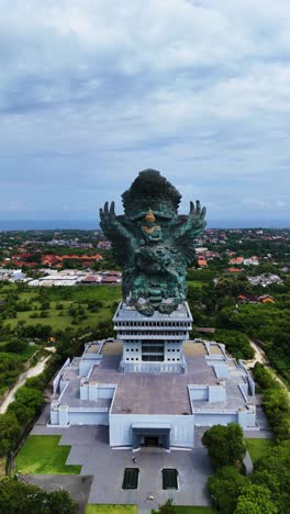 iconic garuda wisnu kencana statue, fly backward vertical view