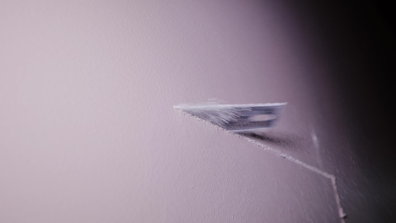 Fine closeup showing precise manual cutting of gypsum board in workshop