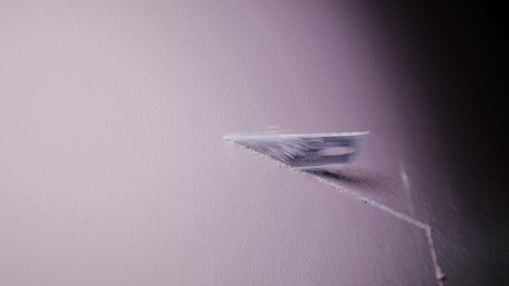 Fine closeup showing precise manual cutting of gypsum board in workshop