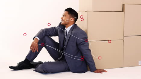 animación de conexiones sobre feliz hombre de negocios caucásico sentado en cajas