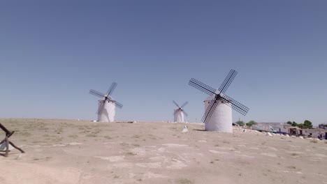 low-altitude aerial view and flight between spanish windmills. spanish windmills and consuegra castle. campo de criptana. la mancha, spain